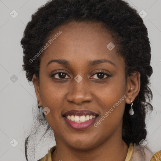 Joyful black young-adult female with long  brown hair and brown eyes