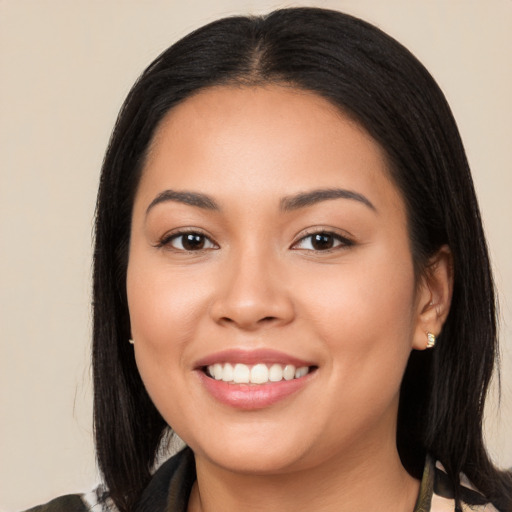 Joyful latino young-adult female with long  black hair and brown eyes