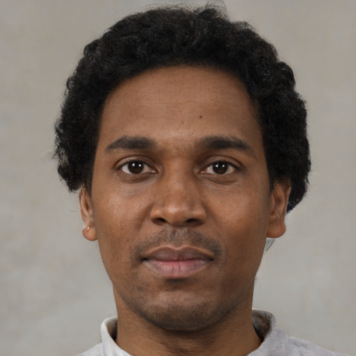 Neutral black adult male with short  black hair and brown eyes