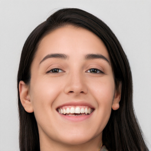 Joyful white young-adult female with long  black hair and brown eyes