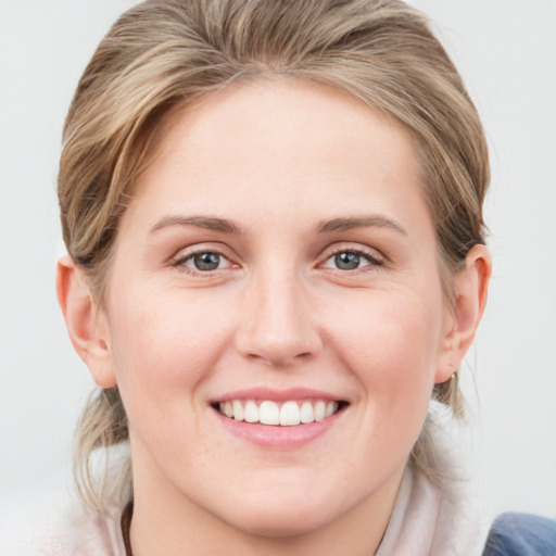 Joyful white young-adult female with medium  brown hair and blue eyes