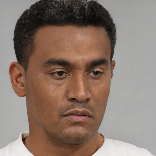 Neutral latino young-adult male with short  brown hair and brown eyes