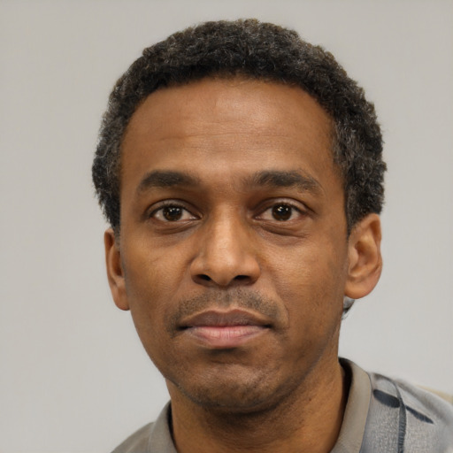 Neutral latino adult male with short  black hair and brown eyes