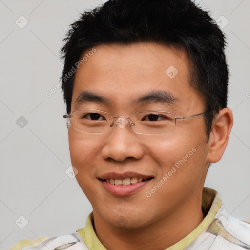 Joyful asian young-adult male with short  black hair and brown eyes