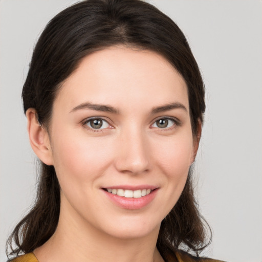 Joyful white young-adult female with medium  brown hair and brown eyes