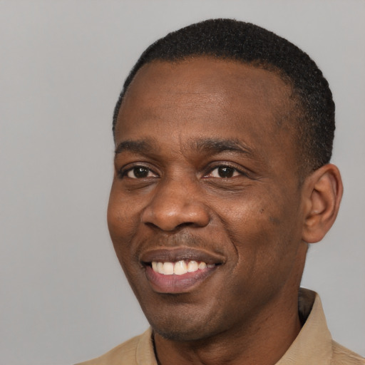 Joyful latino adult male with short  black hair and brown eyes