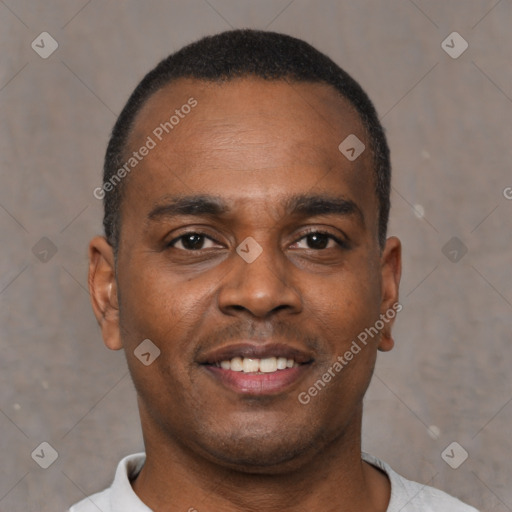 Joyful black young-adult male with short  brown hair and brown eyes