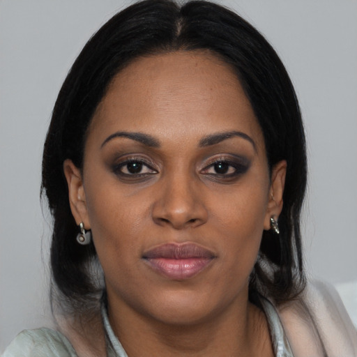 Joyful black young-adult female with medium  brown hair and brown eyes