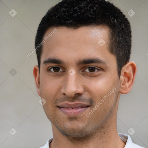 Joyful latino young-adult male with short  black hair and brown eyes