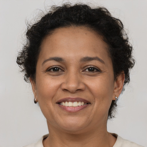 Joyful latino adult female with short  brown hair and brown eyes