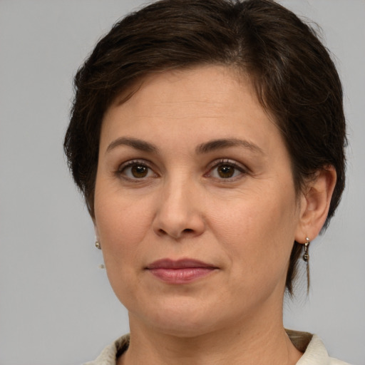 Joyful white adult female with medium  brown hair and brown eyes