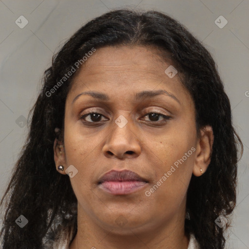 Joyful black adult female with long  brown hair and brown eyes