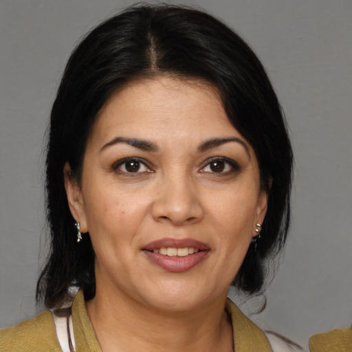 Joyful white adult female with medium  brown hair and brown eyes