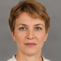 Joyful white adult female with short  brown hair and grey eyes