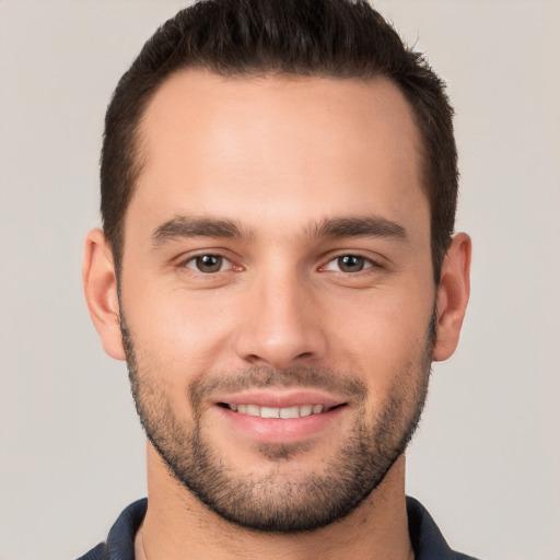 Joyful white young-adult male with short  brown hair and brown eyes