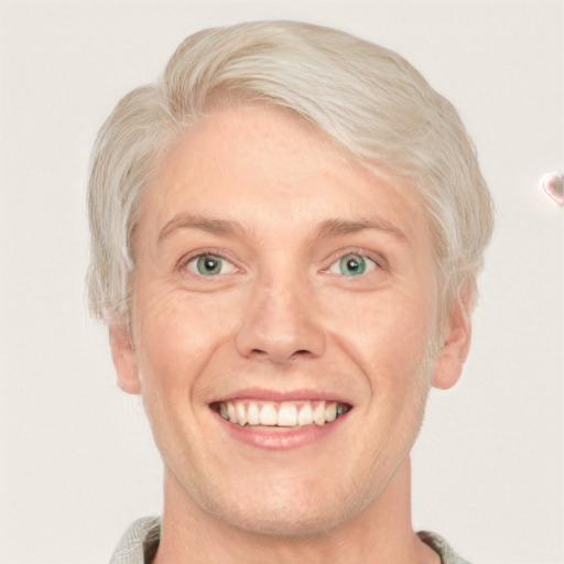 Joyful white adult male with short  blond hair and blue eyes