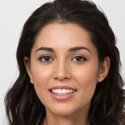 Joyful white young-adult female with long  brown hair and brown eyes