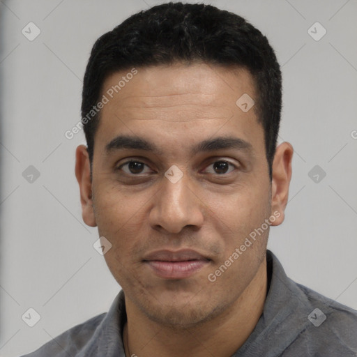 Joyful white young-adult male with short  black hair and brown eyes