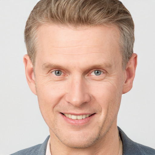 Joyful white adult male with short  brown hair and grey eyes