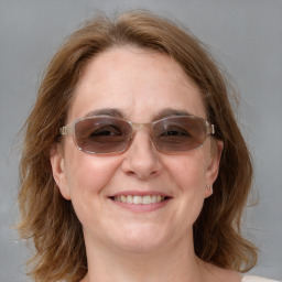 Joyful white adult female with medium  brown hair and blue eyes