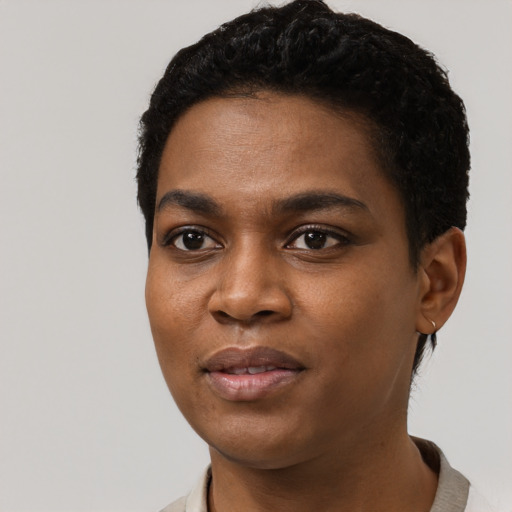 Joyful black young-adult female with short  black hair and brown eyes