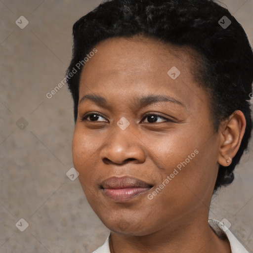 Joyful black young-adult female with short  black hair and brown eyes