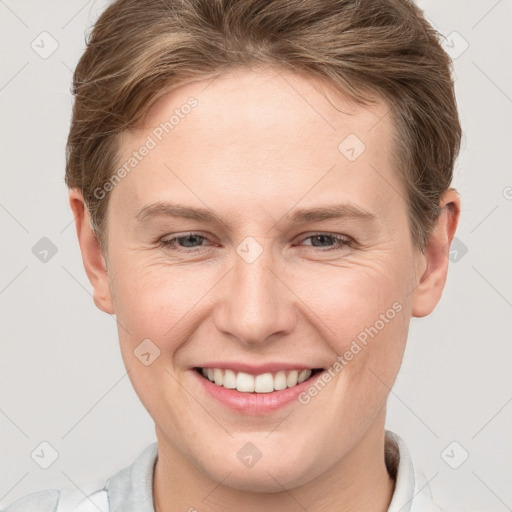 Joyful white young-adult female with short  brown hair and grey eyes