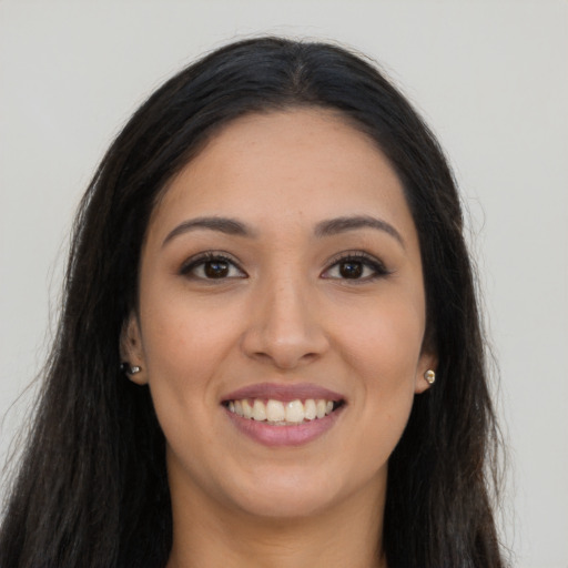 Joyful latino young-adult female with long  brown hair and brown eyes