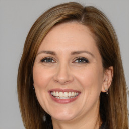 Joyful white adult female with long  brown hair and brown eyes