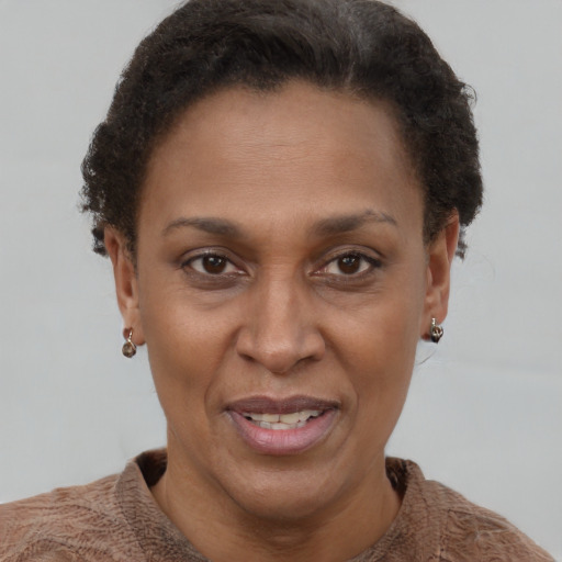 Joyful black adult female with short  brown hair and brown eyes