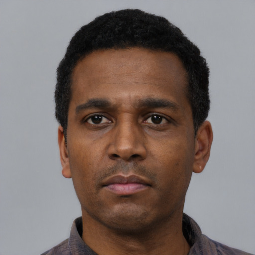 Neutral black adult male with short  black hair and brown eyes