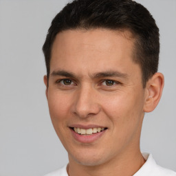 Joyful white young-adult male with short  brown hair and brown eyes