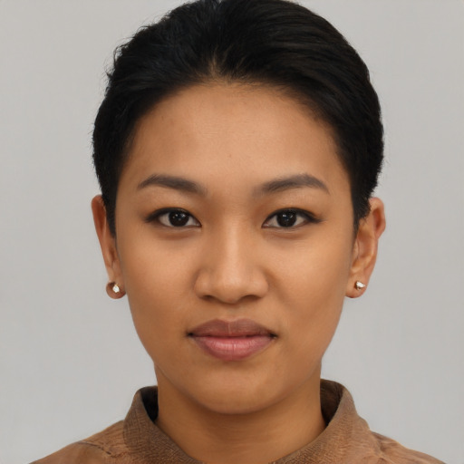 Joyful latino young-adult female with short  black hair and brown eyes