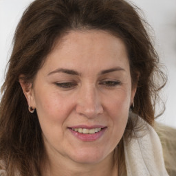 Joyful white adult female with long  brown hair and brown eyes