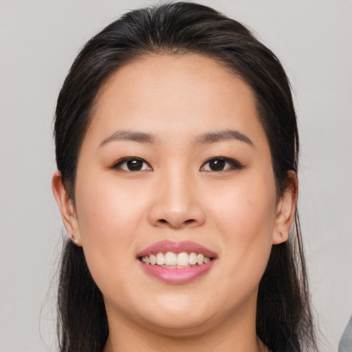 Joyful asian young-adult female with long  brown hair and brown eyes