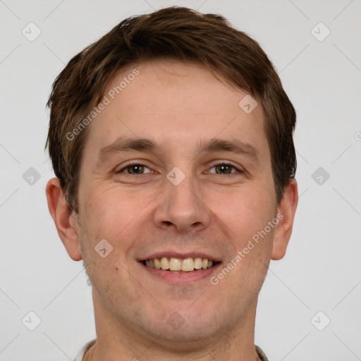 Joyful white adult male with short  brown hair and grey eyes