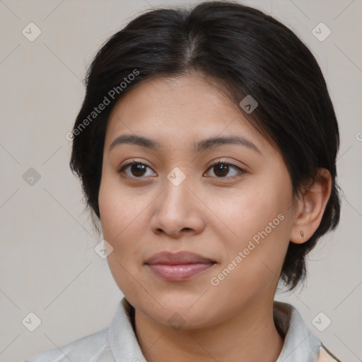 Joyful latino young-adult female with medium  brown hair and brown eyes