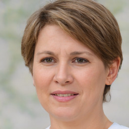 Joyful white adult female with medium  brown hair and grey eyes