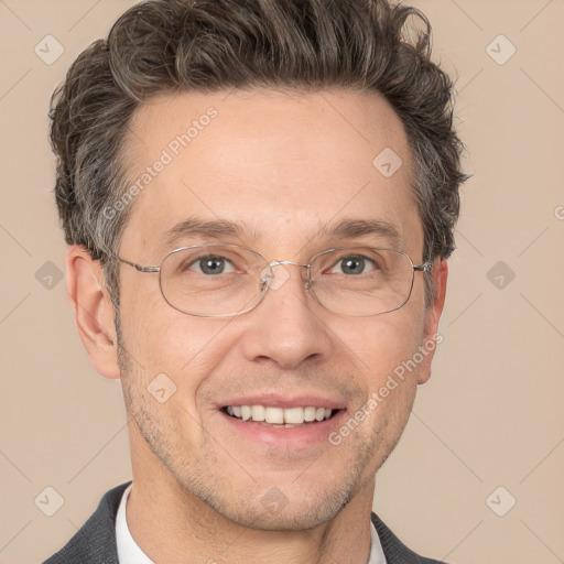 Joyful white adult male with short  brown hair and grey eyes