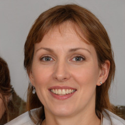 Joyful white young-adult female with medium  brown hair and blue eyes