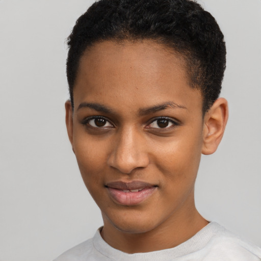 Joyful black young-adult female with short  black hair and brown eyes