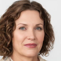 Joyful white young-adult female with medium  brown hair and green eyes