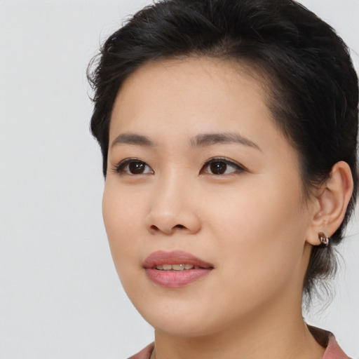 Joyful asian young-adult female with medium  brown hair and brown eyes