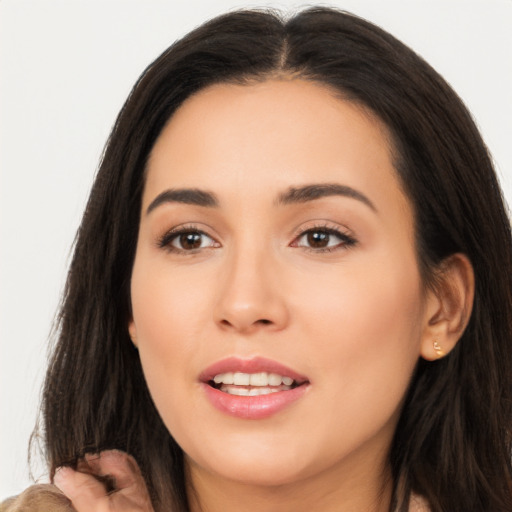 Joyful latino young-adult female with long  brown hair and brown eyes