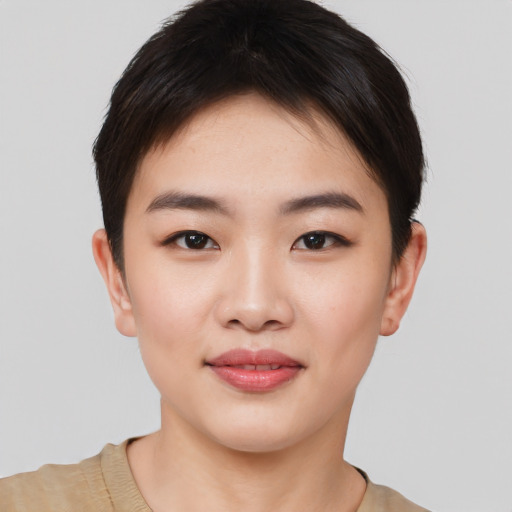 Joyful asian young-adult female with short  brown hair and brown eyes