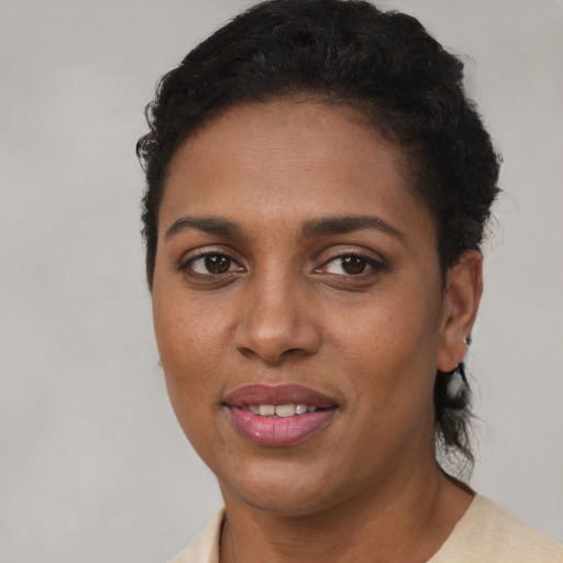 Joyful black young-adult female with short  brown hair and brown eyes