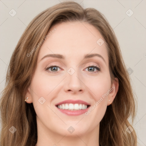 Joyful white young-adult female with long  brown hair and blue eyes