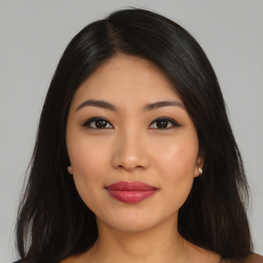 Joyful latino young-adult female with long  black hair and brown eyes