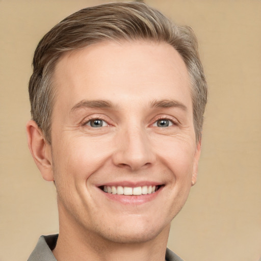 Joyful white adult male with short  brown hair and grey eyes