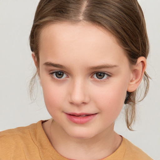 Joyful white child female with medium  brown hair and brown eyes